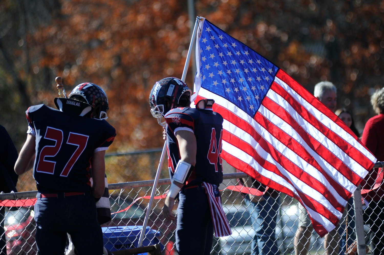 Showing their colors. Before the start of the game, several Bears seniors took to the field with patriotic flags, including Old Glory. Pictured are Ian Mullen and Dylan Poley with the American flag. At 8:24 in the first frame, Poley intercepted a Pine Plains pass to score the game’s first TD in Tri-Valley’s 45-38 win over the Bombers.